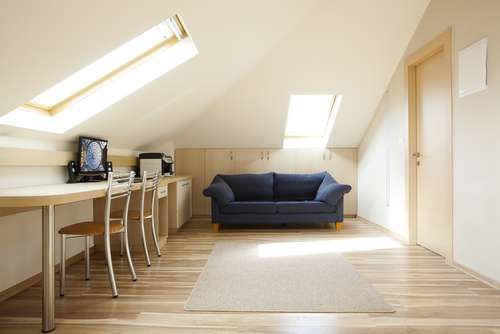 There is a couch and a desk in the attic.