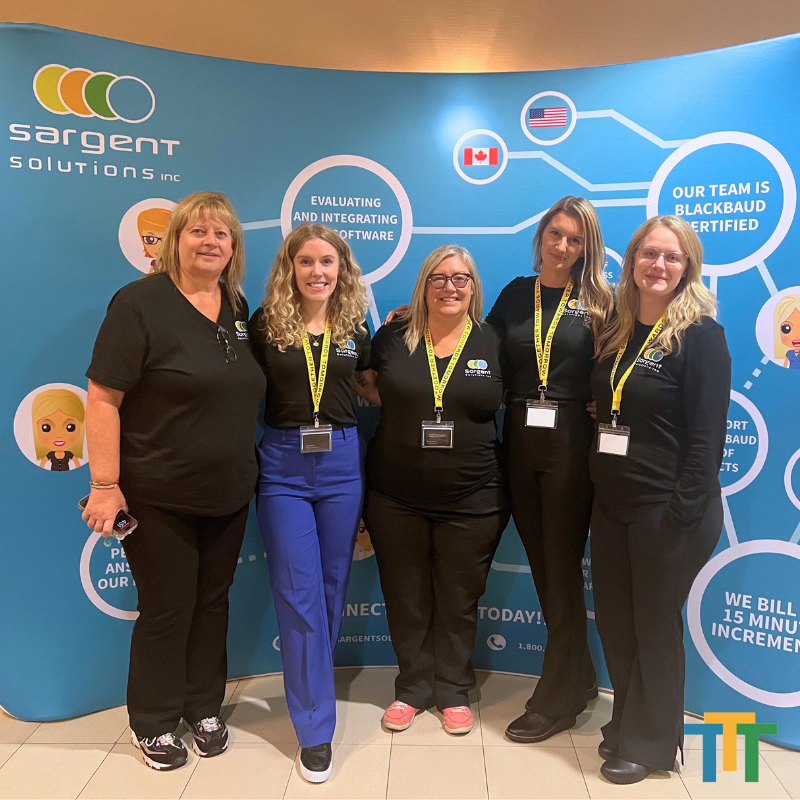 A group of women standing in front of a sign that says sargent solutions