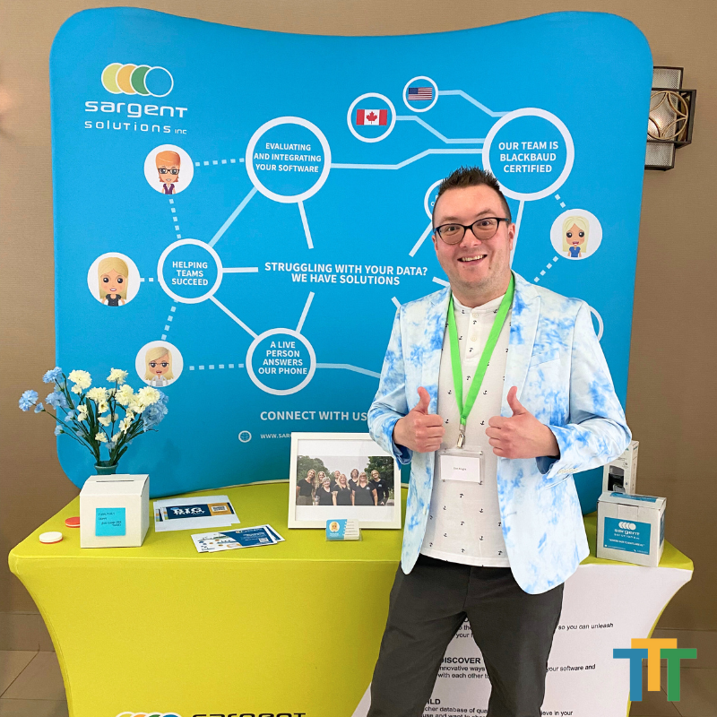 A man standing in front of a sign that says sargent solutions