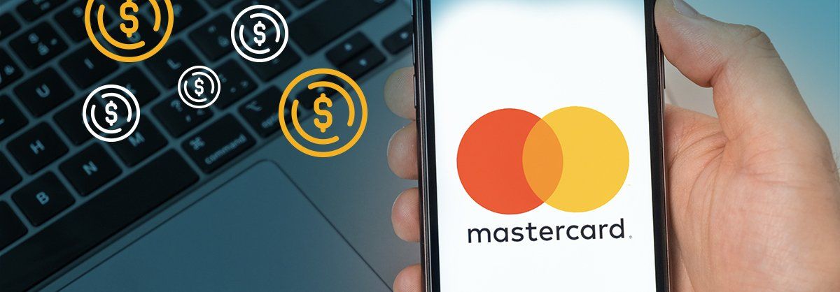 A person is holding a smart phone with the mastercard logo on it.