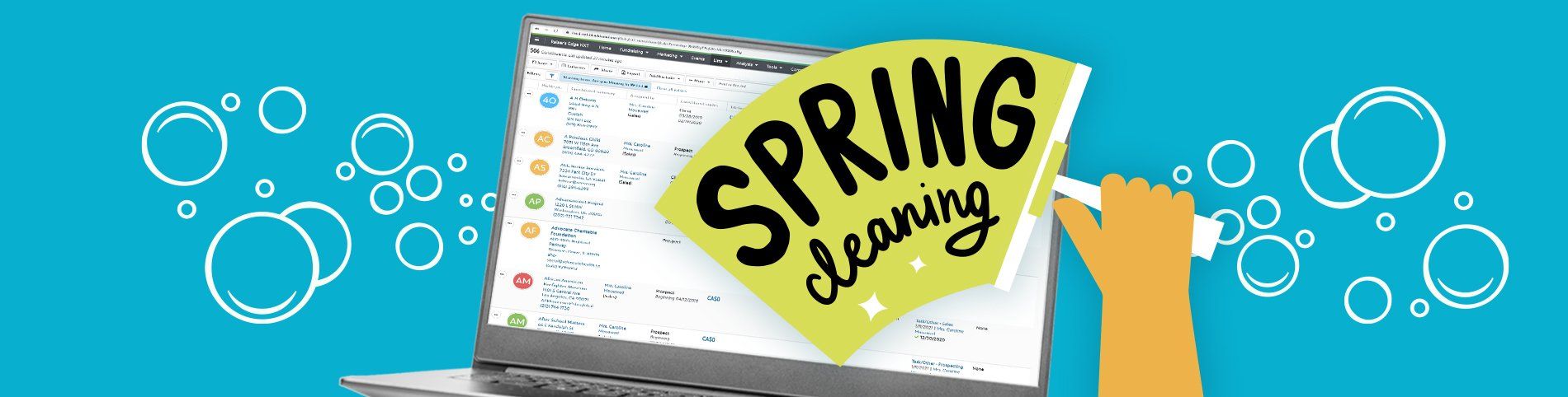 A person is cleaning a laptop with a spring cleaning sticker on it.