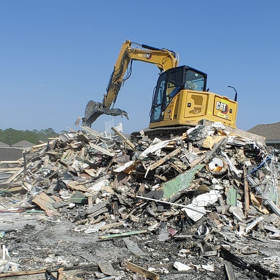An excavator demolishing a home in Biloxi, MS