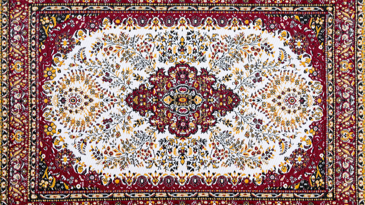 Red and white patterned oriental rug with floral design.