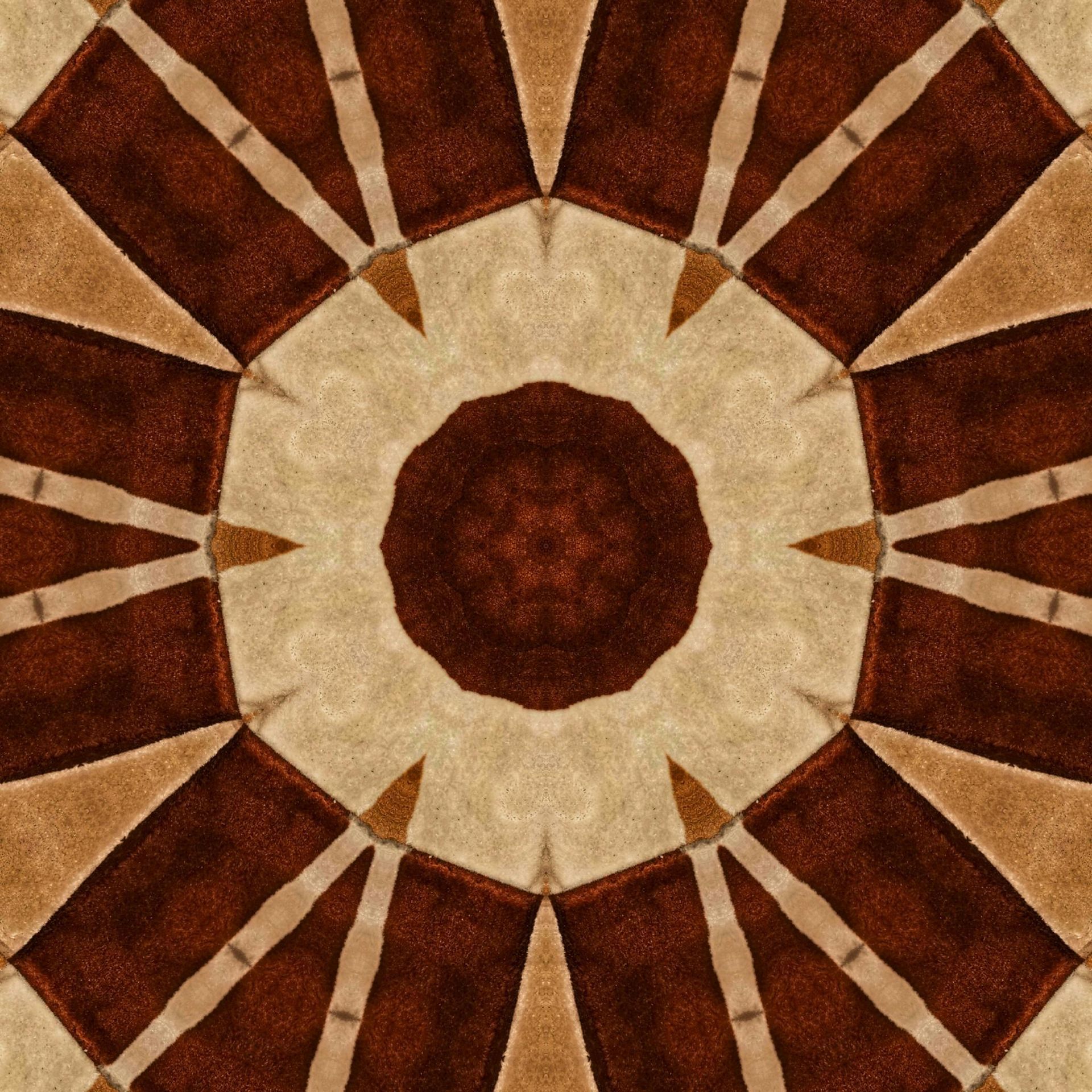 Kaleidoscopic pattern of brown and beige brickwork, forming an octagonal design with a central floral-like shape.