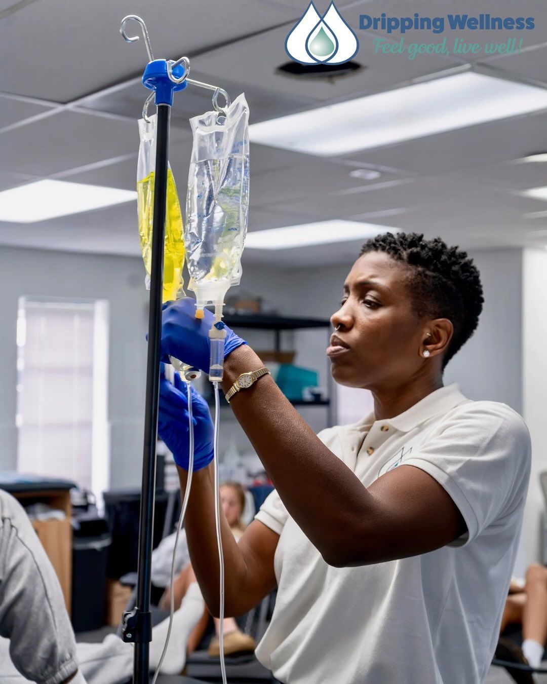 Nurse preparing IV drip bags in a clinic setting.