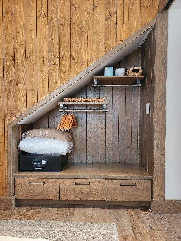 There is a closet under the stairs with drawers and shelves.