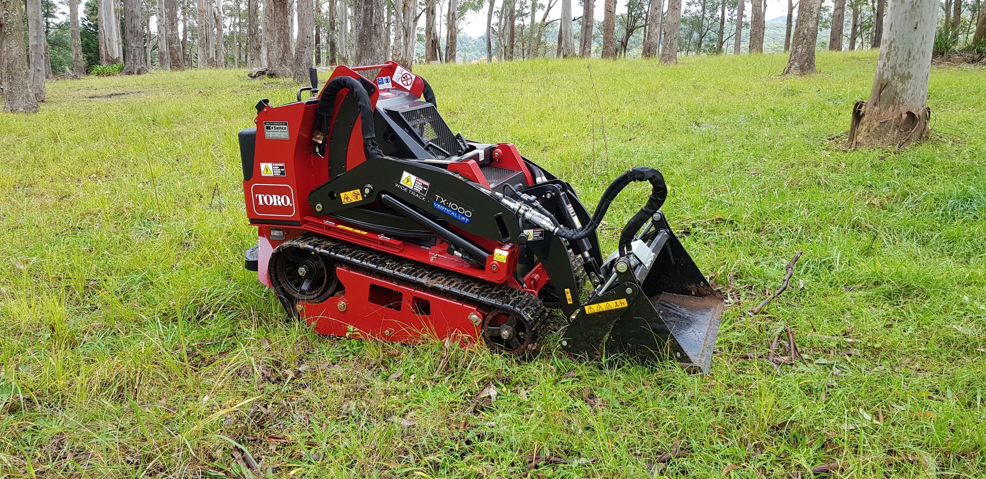 Orange Excavator On The Background Of A Meadow And Trees — Wallaroo Landscapes In Nowra NSW