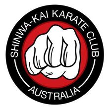 Shinwa-Kai Karate Club Australia logo with a white fist on a black and red circular badge