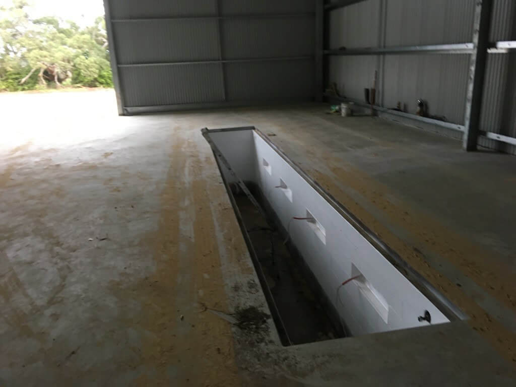 Concrete slab including aprons and 8m pit with bessa block wall for this industrial shed