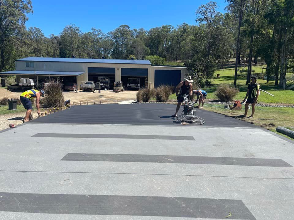 Workers Paving a Driveway, With Dark Asphalt Stripes — Wal's Concreting Service Pty Ltd in North Casino, NSW