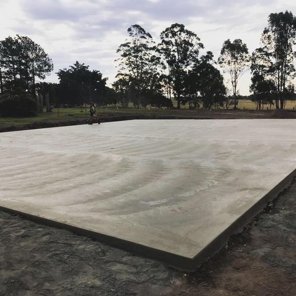 A large concrete slab with decorative concreting is poured on a field — Wal's Concreting Service Pty Ltd in Ballina, NSW