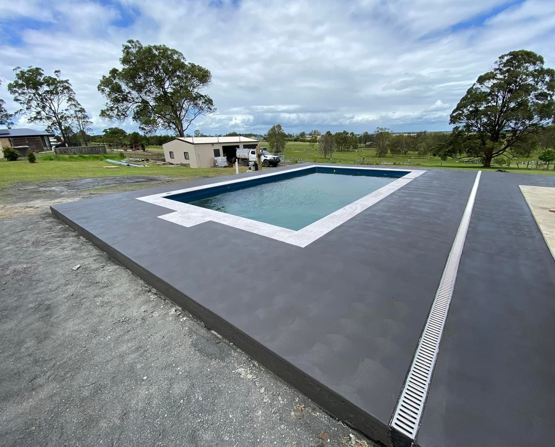 A pool is surrounded by decorative concrete — Wal's Concreting Service Pty Ltd in Kyogle, NSW