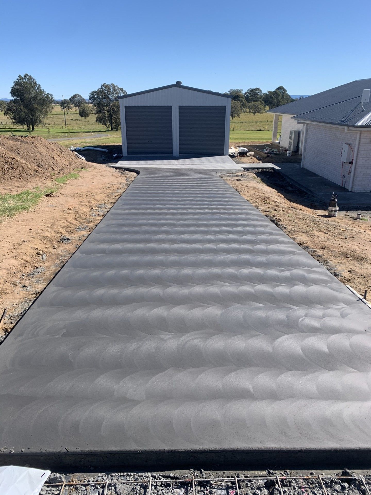 A long driveway is heading to a shed — Wal's Concreting Service Pty Ltd in Lismore, NSW