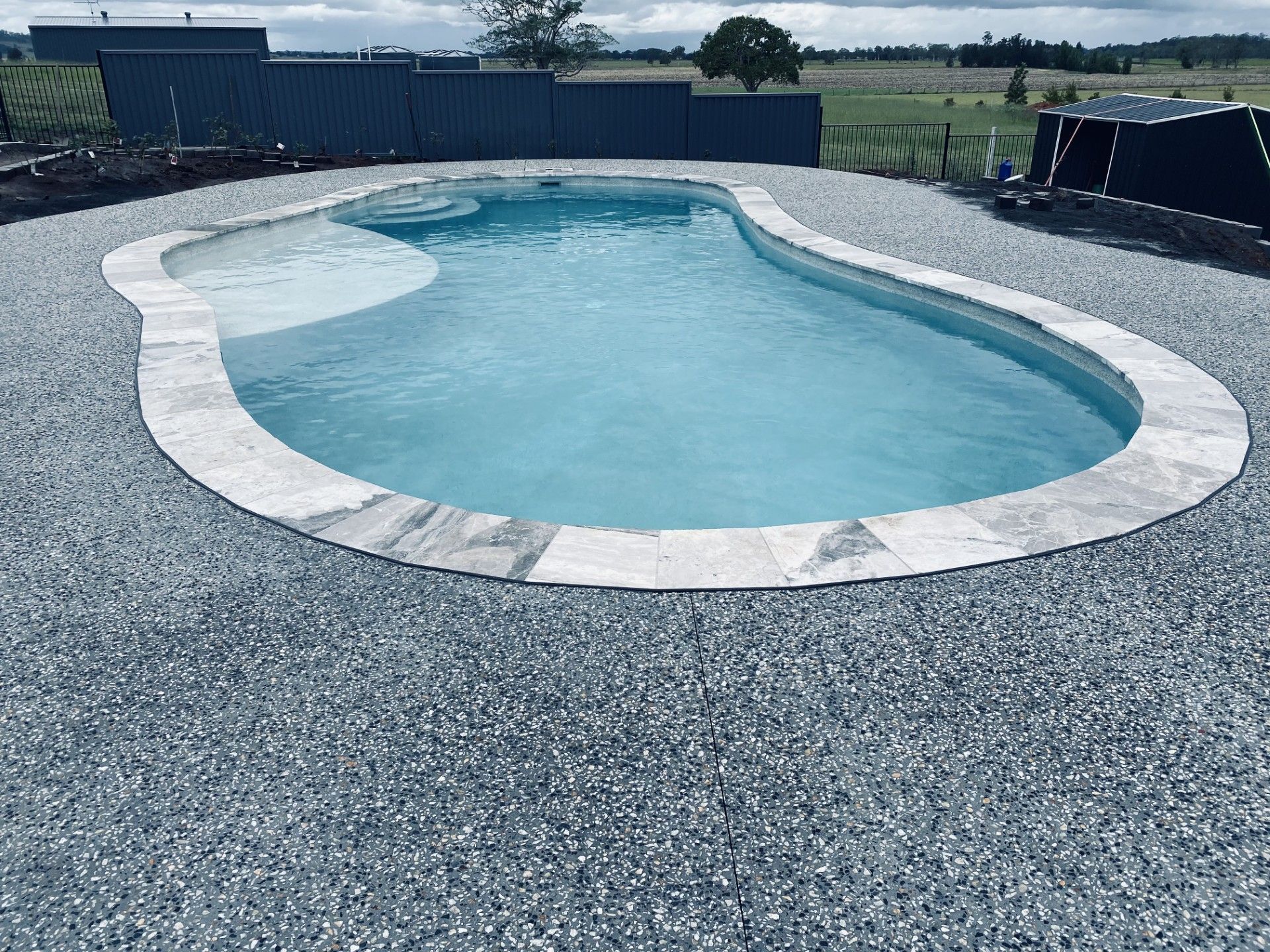 A large circular pool is surrounded by decorative concrete — Wal's Concreting Service Pty Ltd in Casino, NSW