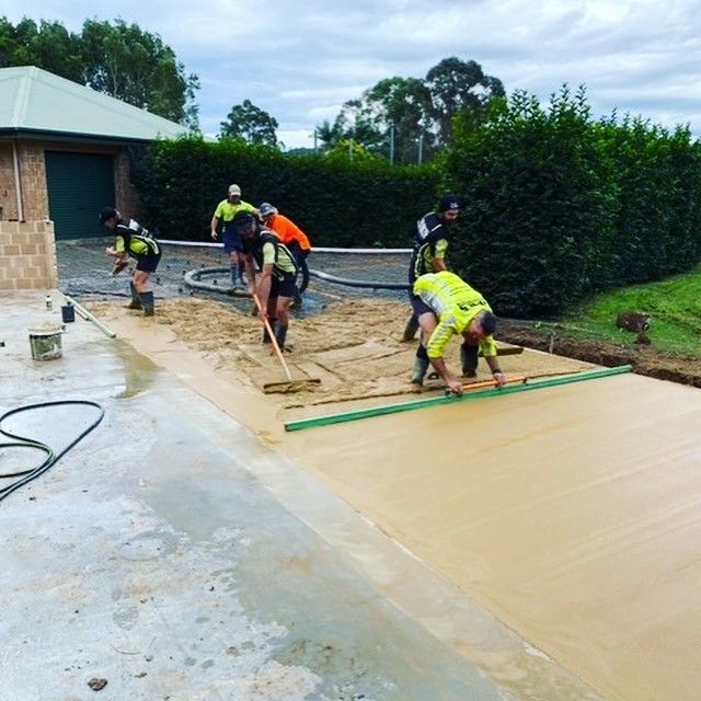 A bunch of workers are laying a new concrete driveway — Wal's Concreting Service Pty Ltd in Kyogle, NSW