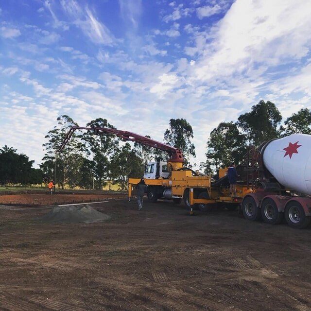 Concrete Truck Pouring Concrete at a Construction Site on a Sunny Day — Wal's Concreting Service Pty Ltd in North Casino, NSW