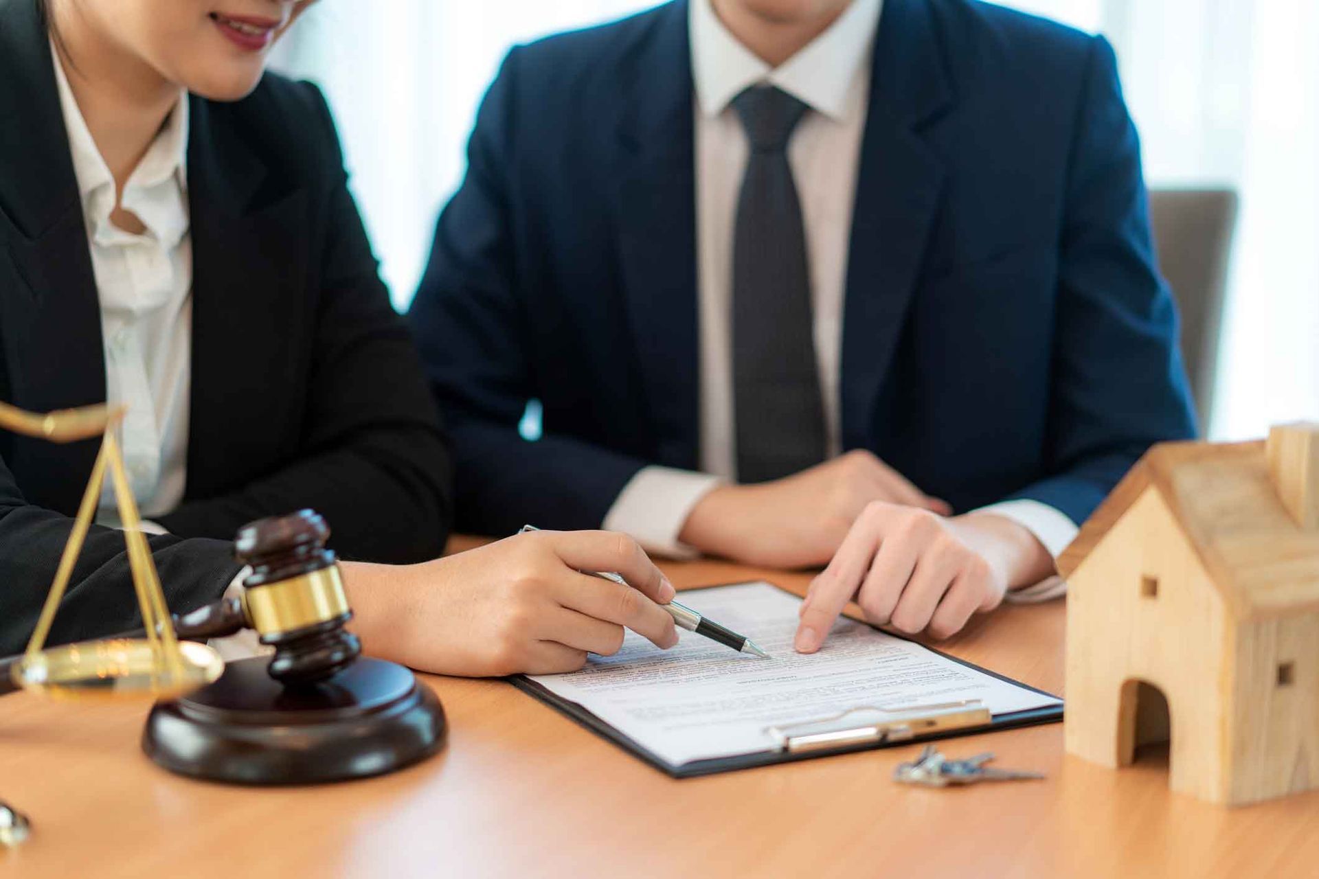 A man and a woman are sitting at a table looking at a piece of paper.