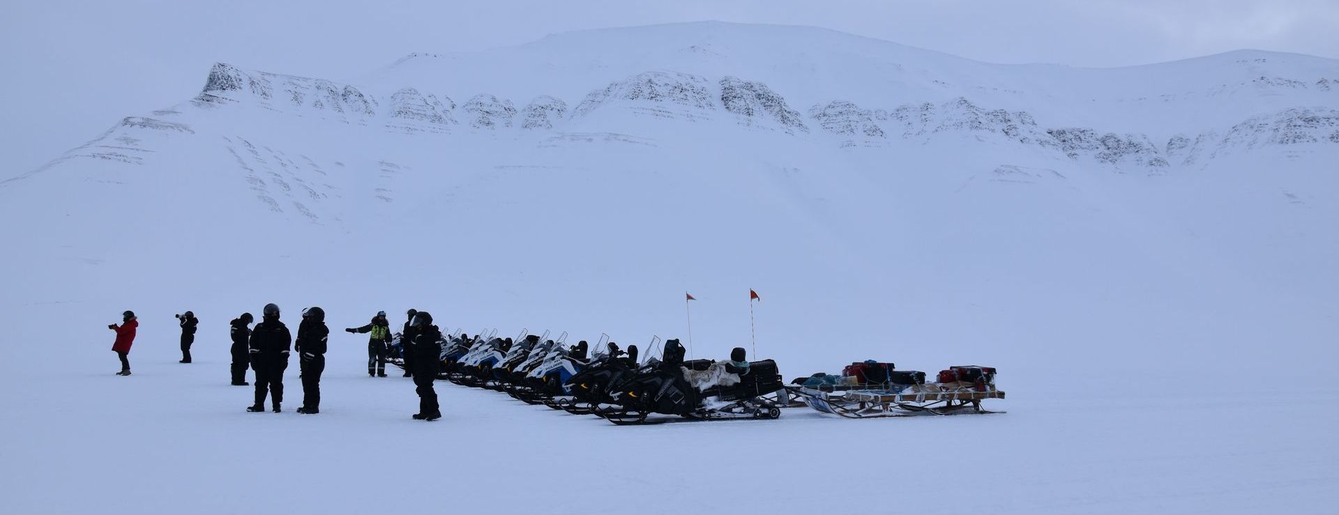 A group of people are standing in the snow.