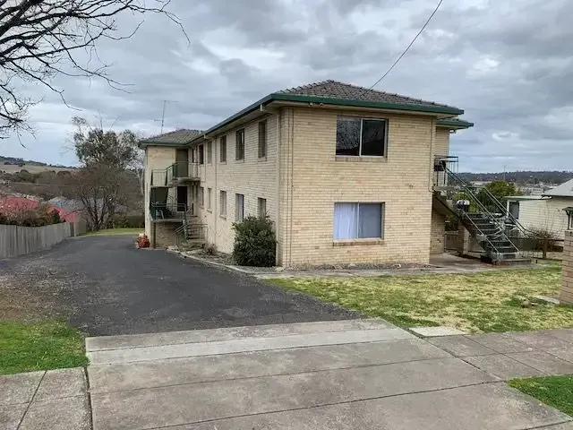 An Apartment Building With Stairs Leading Up To The Second Floor — Tamworth Strata Management Services in Armidale, NSW