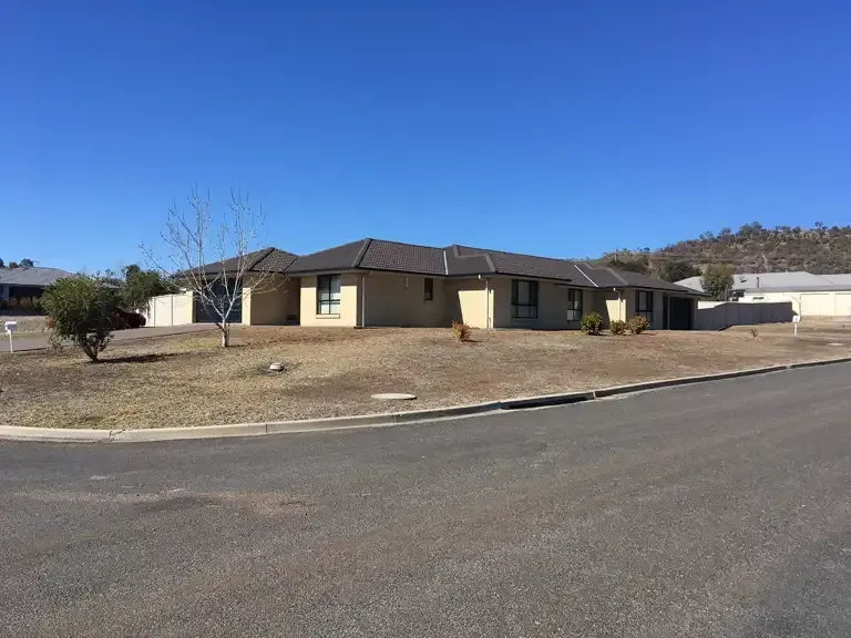 A House With A Brown Roof Is Sitting On The Side Of A Road — Tamworth Strata Management Services in Tamworth, NSW