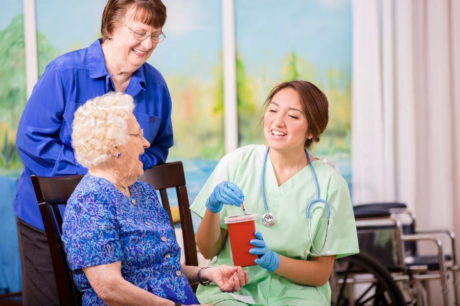 2 old ladies talking with the nurse