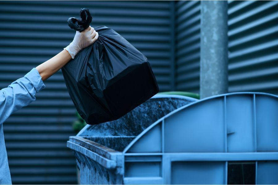 trash to be dumped in a dumpster