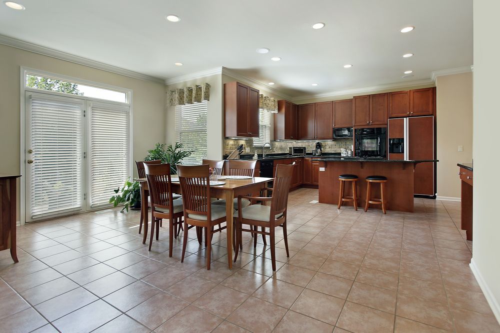 A kitchen with a table and chairs in it.