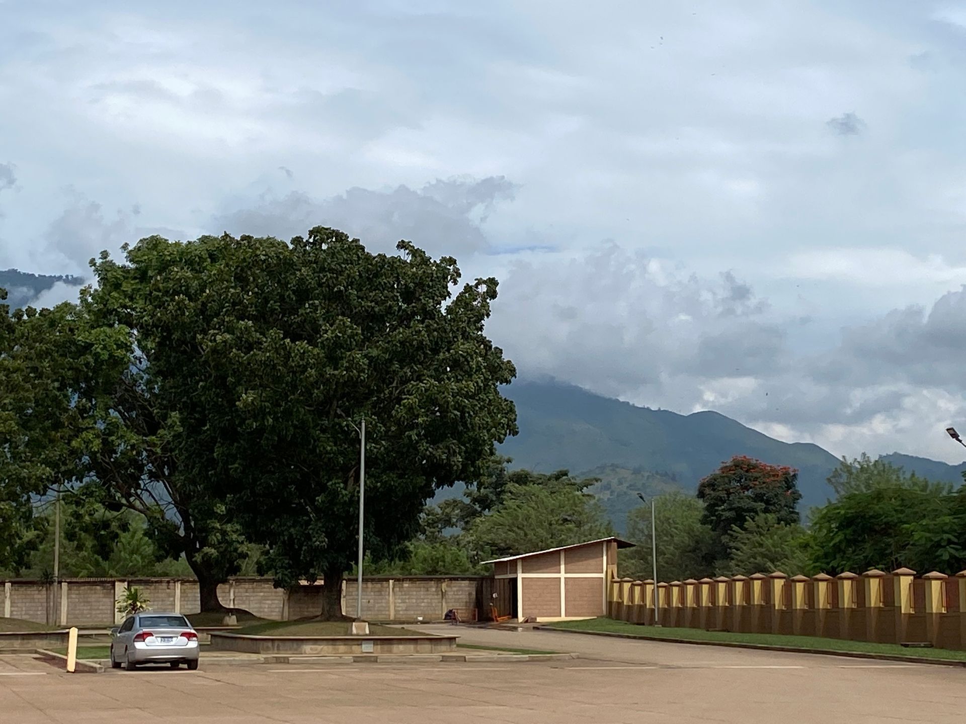 A car is parked in a parking lot with mountains in the background
