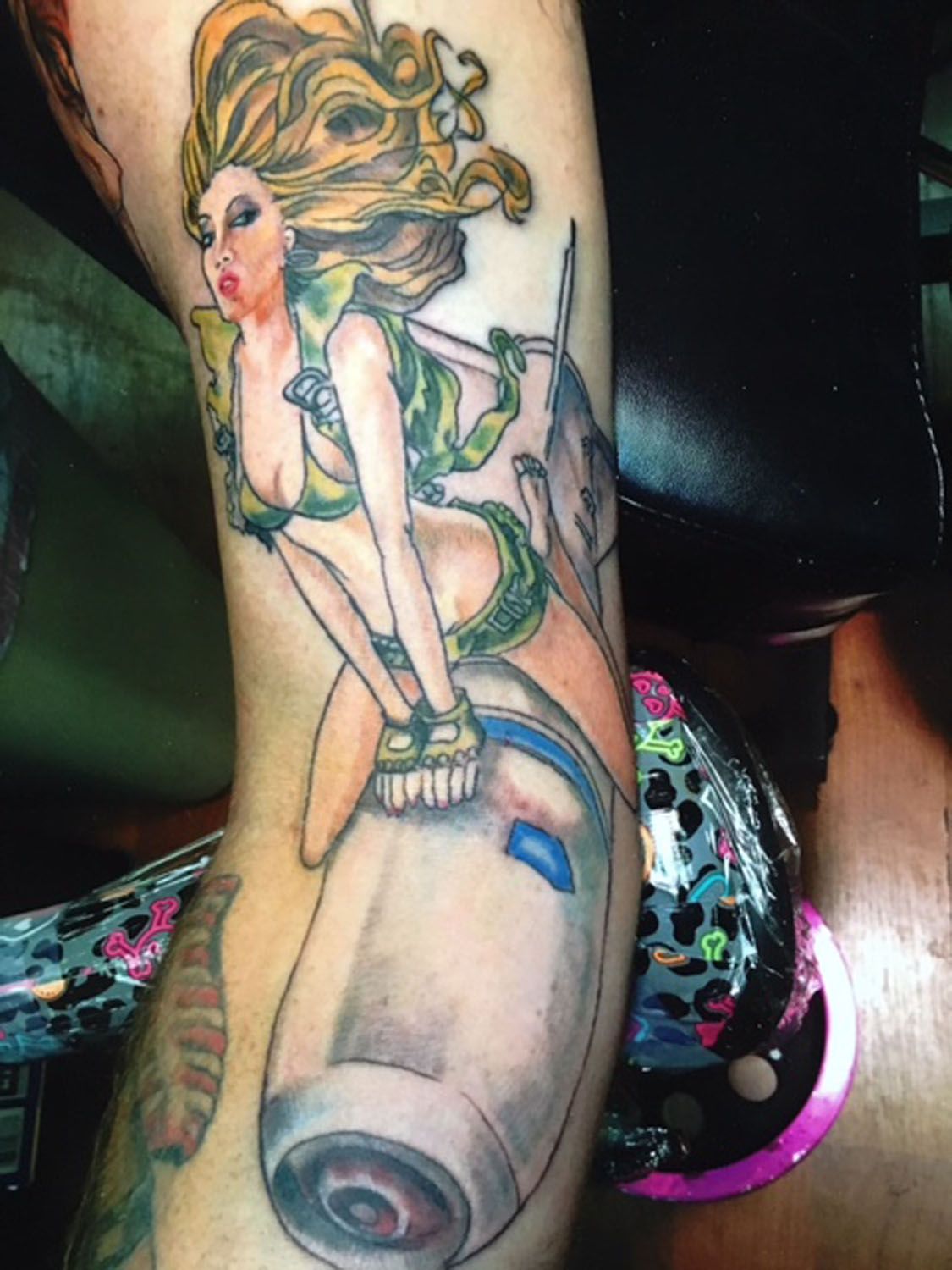 A woman riding a rocket tattoo