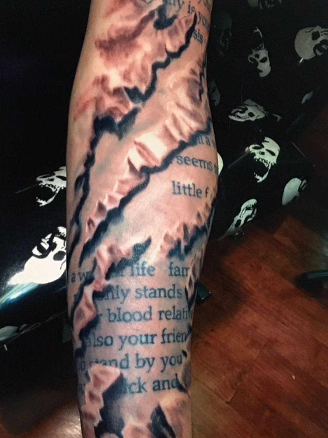 A person has a tattoo on their arm that says life far away