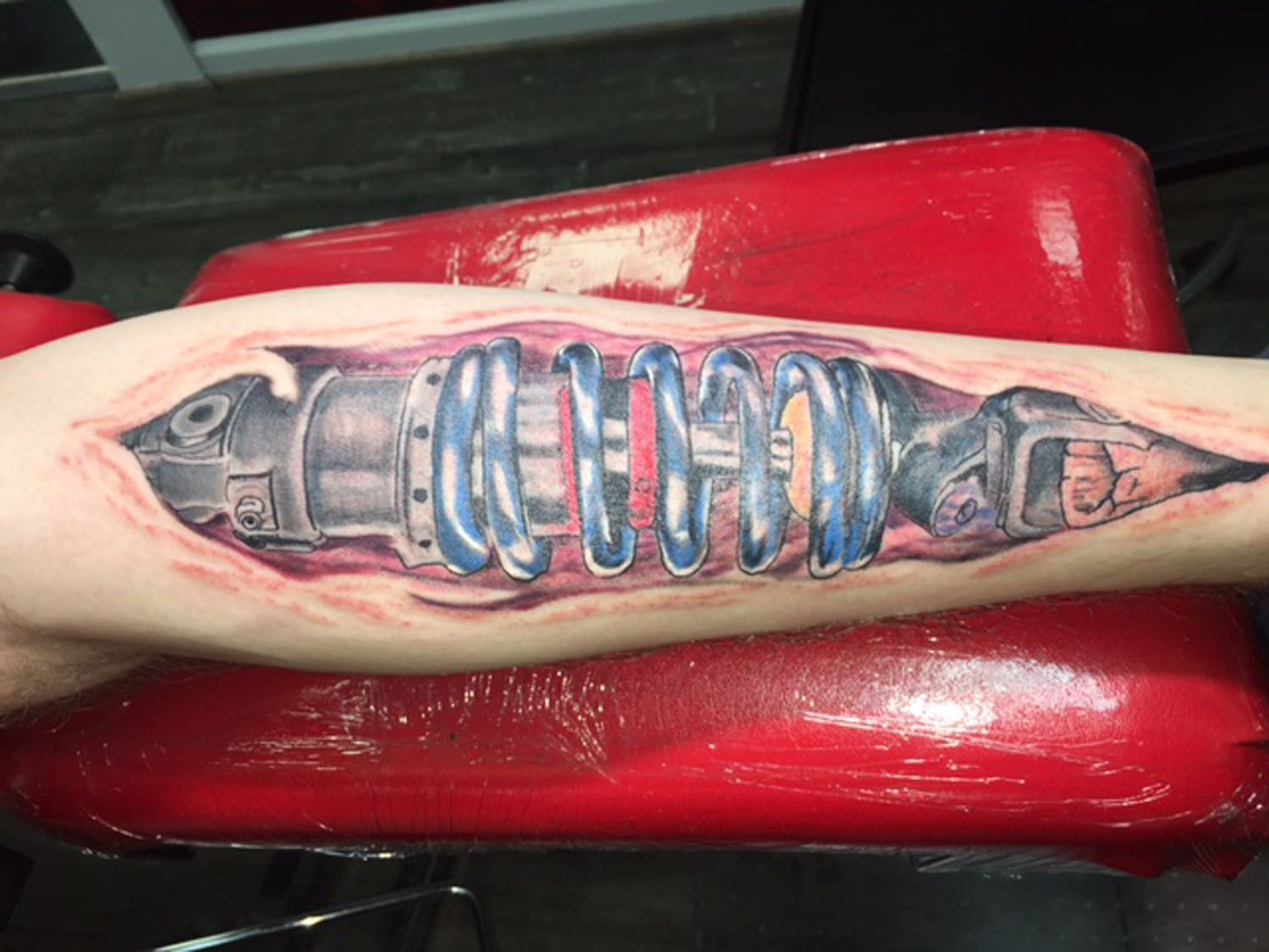 A tattoo on a person 's arm that looks like a fish