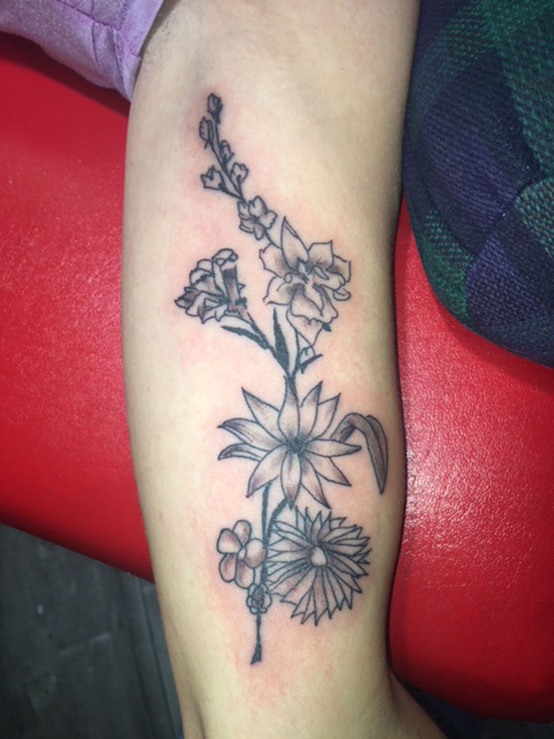 A tattoo of flowers on a person 's arm