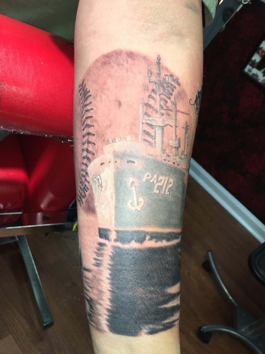 A person has a tattoo on their arm that says pap12