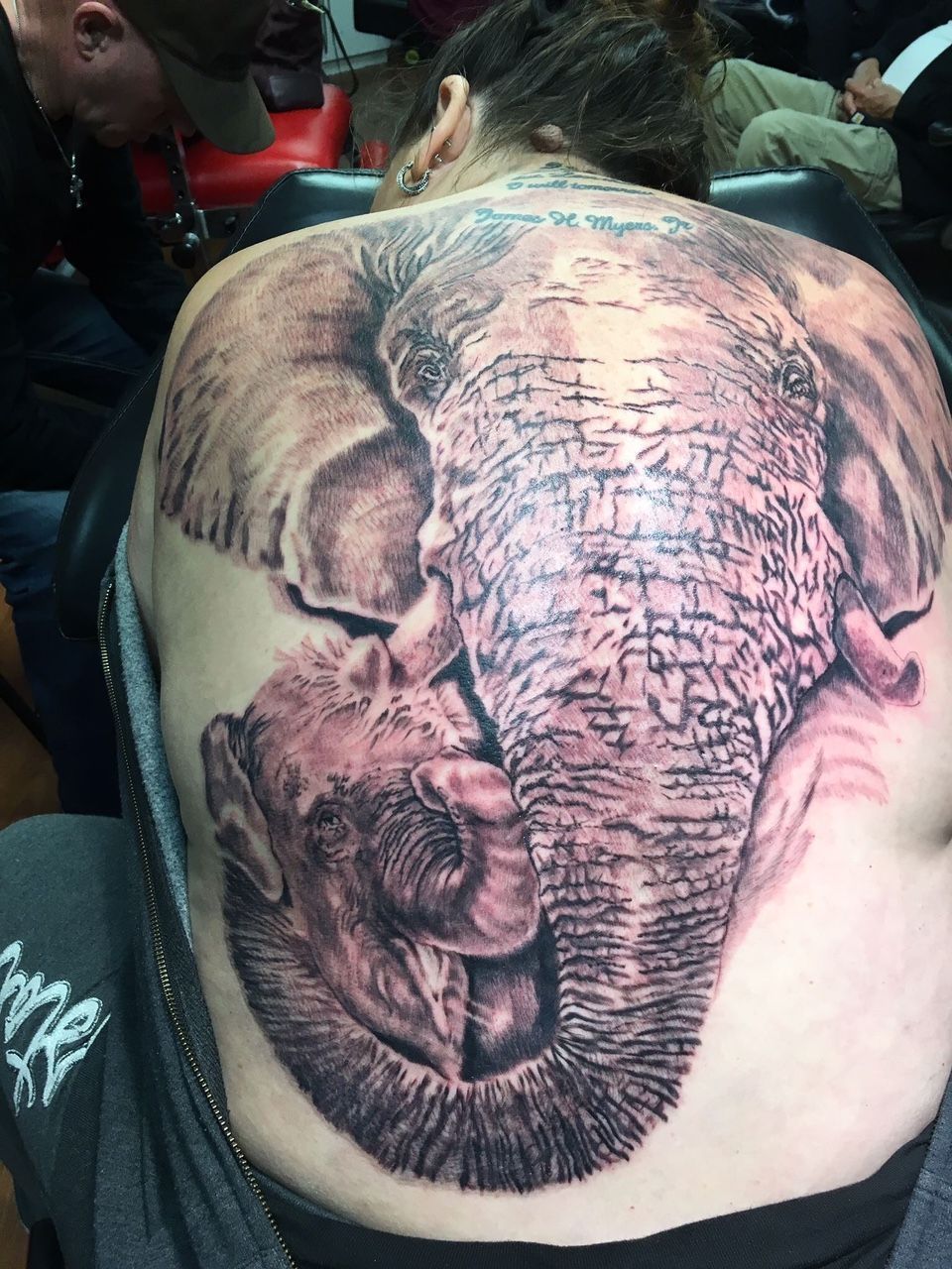 A woman has an elephant tattoo on her back