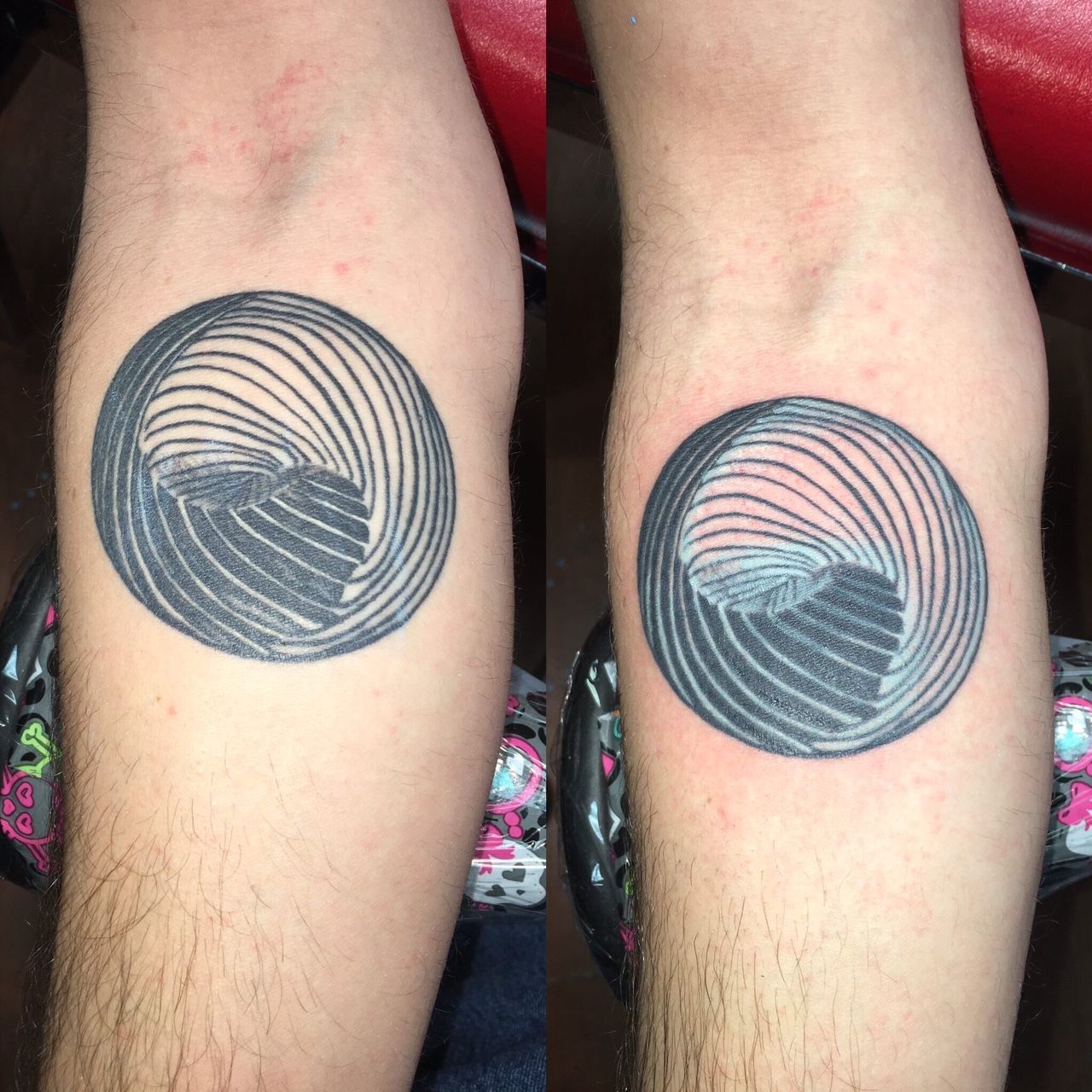 A man has a tattoo of a spiral on his arm