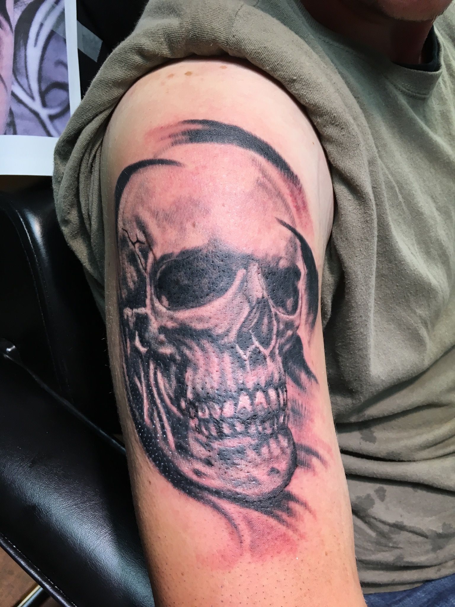 A man has a tattoo of a skull on his arm