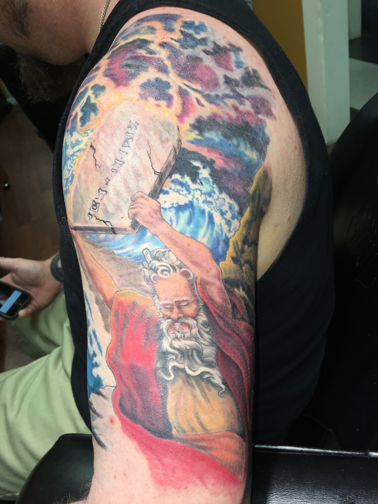 A man carrying stone block tattoo