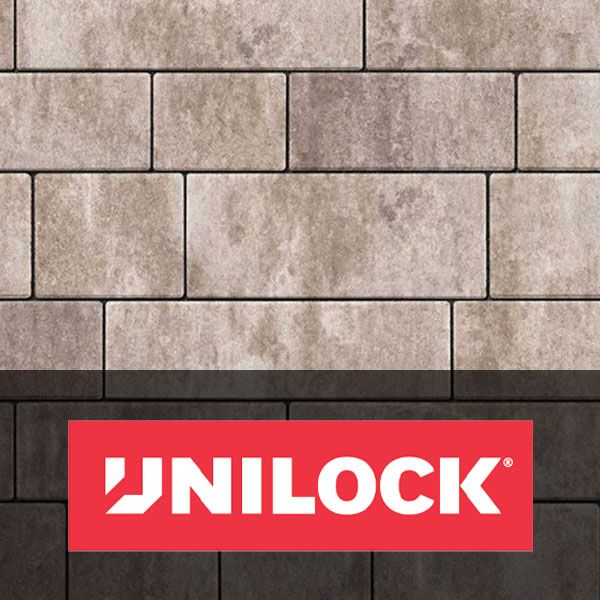 UNILOCK logo on a red banner over a beige stone paver wall