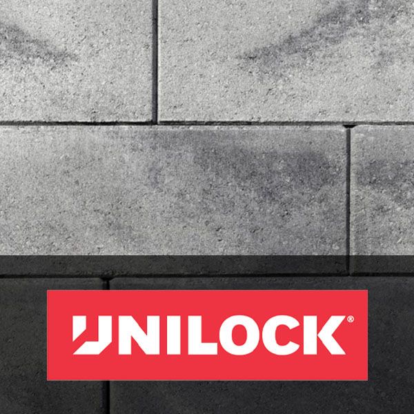 UNILOCK logo on gray stone wall with red banner