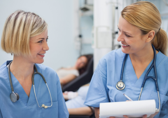 Two nurses are talking to each other