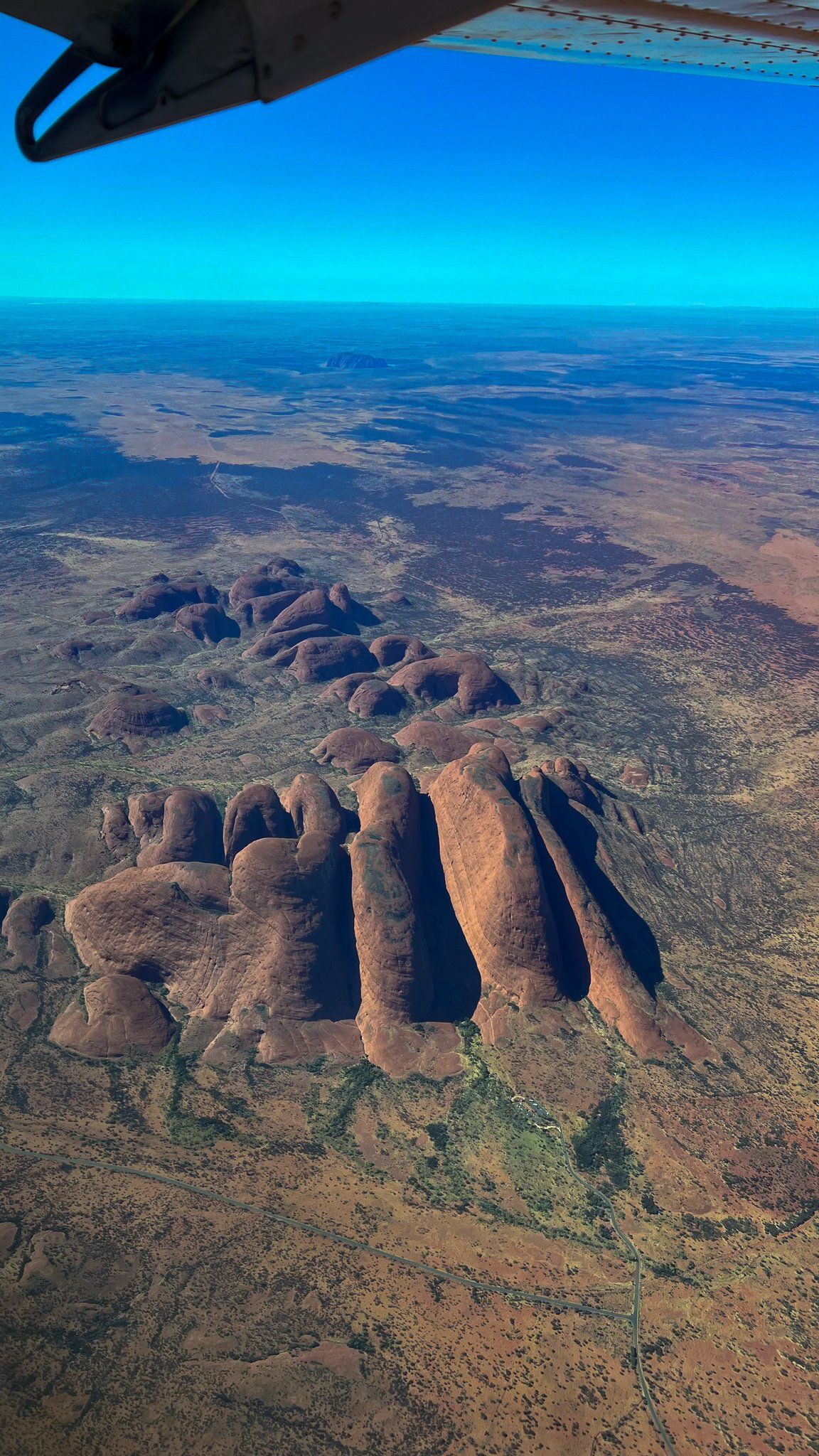 Chartair Mail Plane flies over Uluru