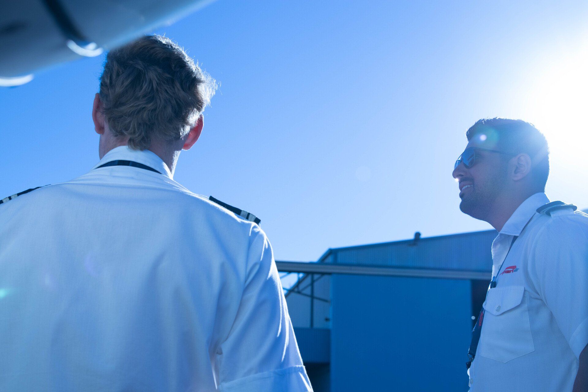 Two Chartair pilots talking on the ground