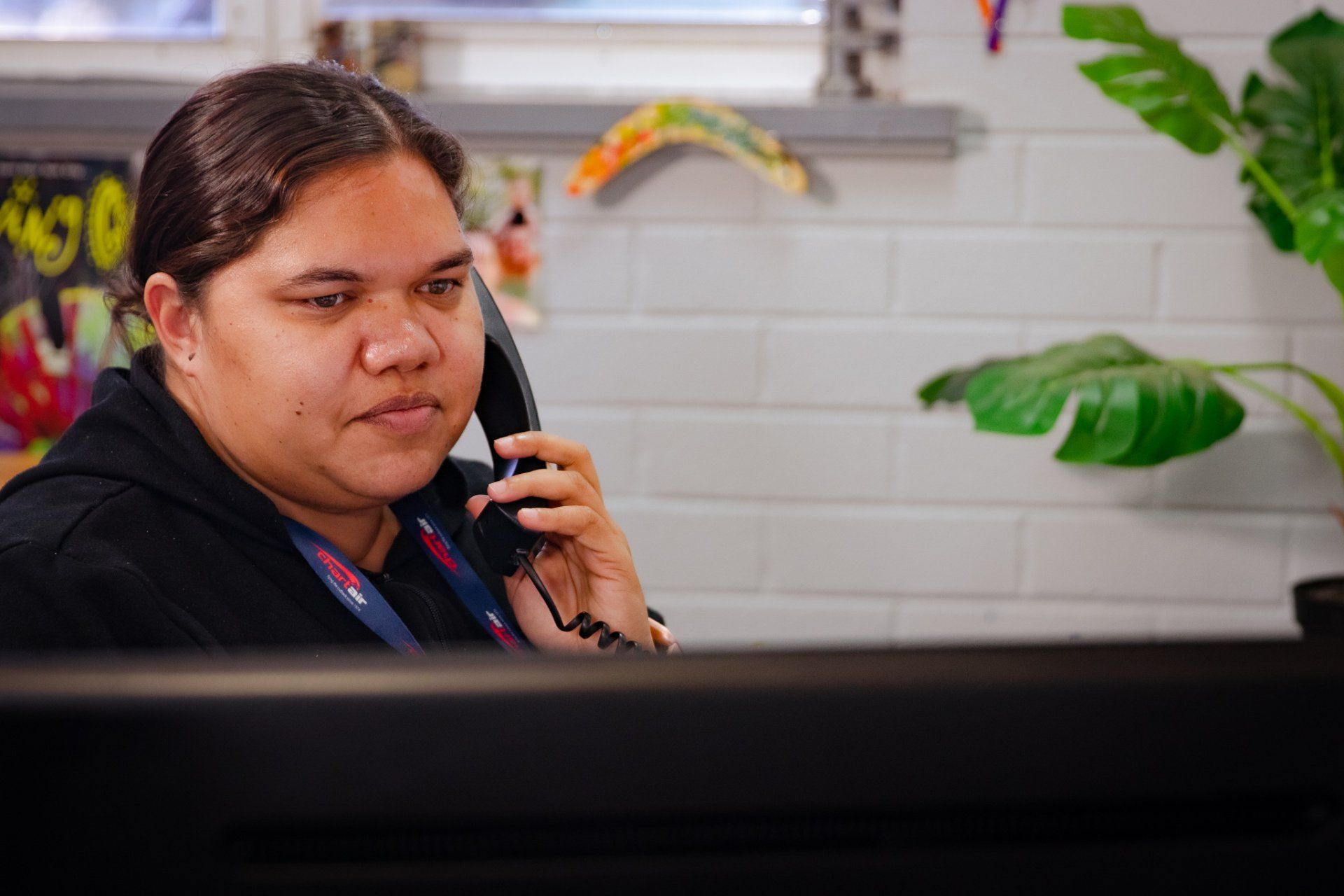 Chartair's team member Jaylene taking on the phone
