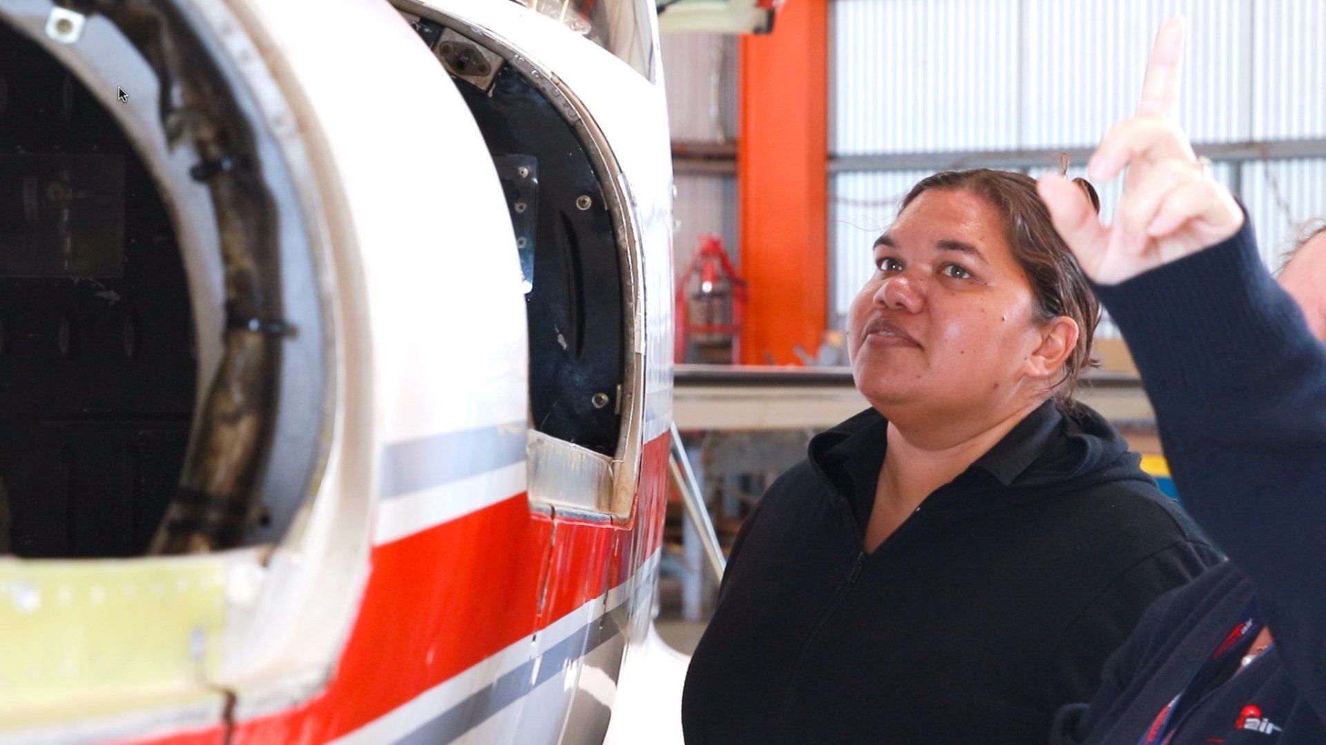 Chartair's team member Jaylene is looking at an airplane