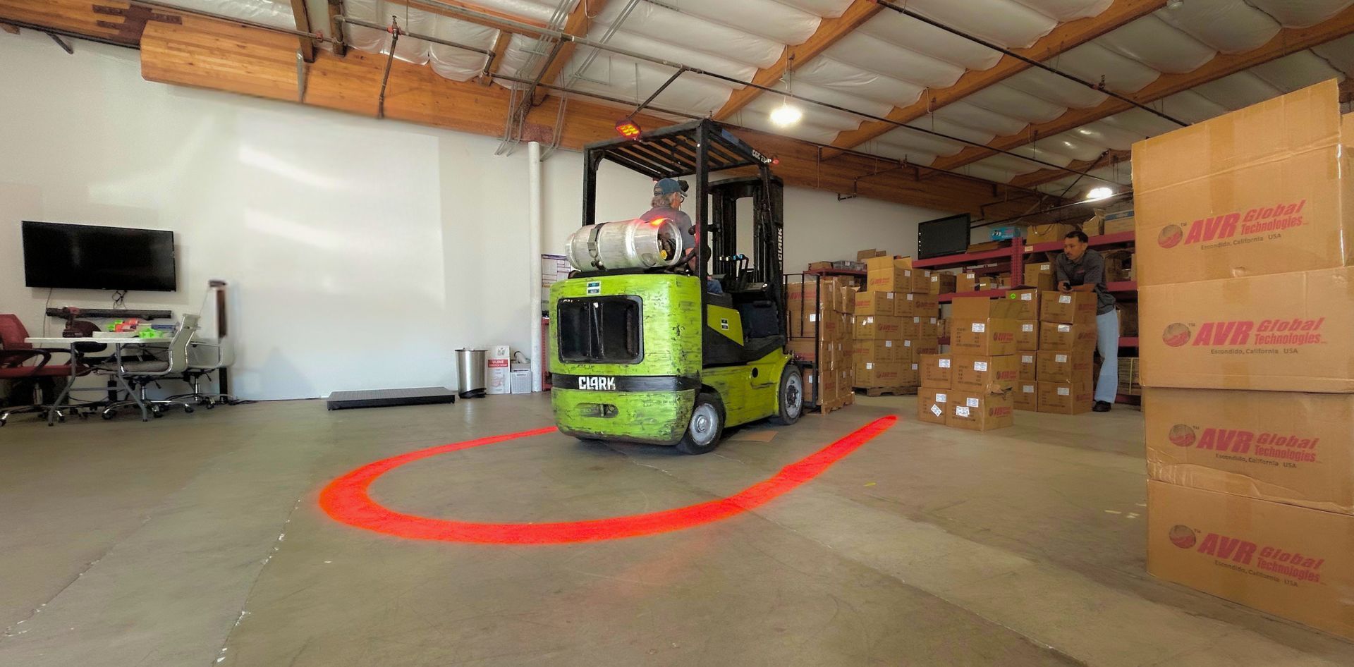 Worker adjusting beacon light on heavy equipment