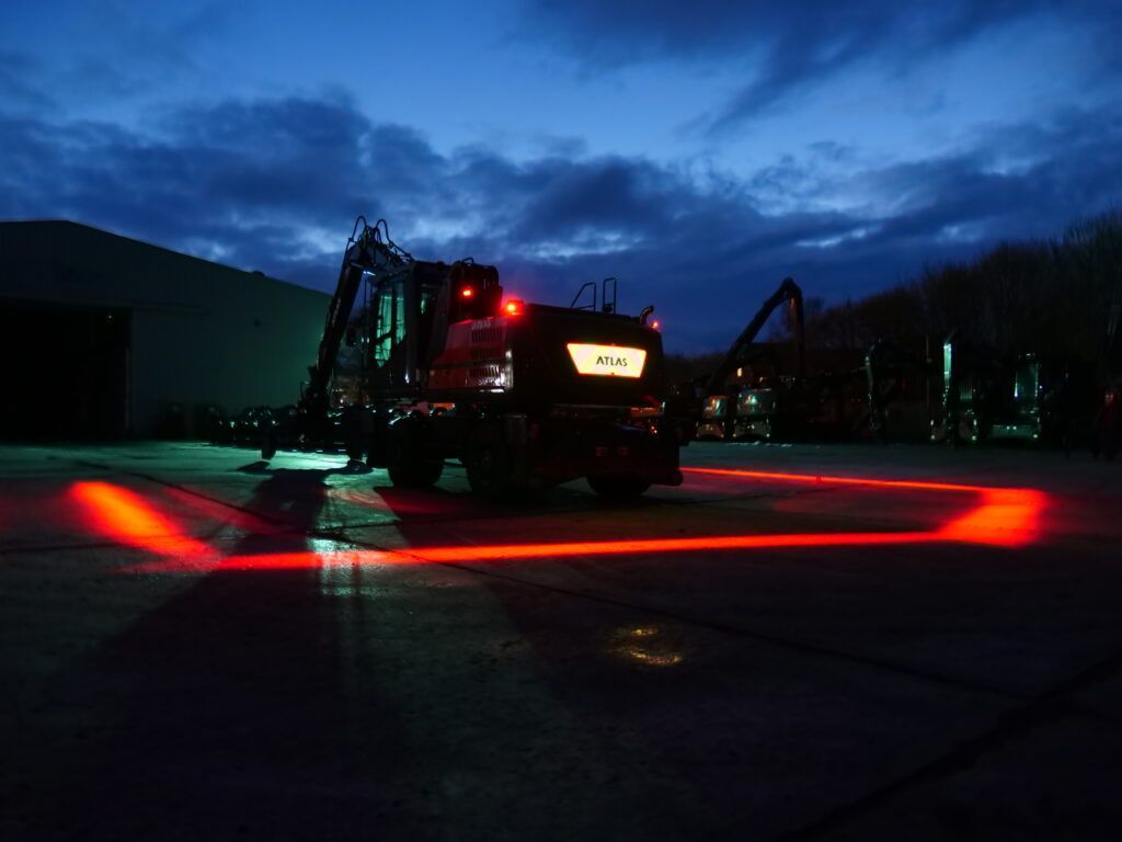 Night excavation site with amber beacon lights