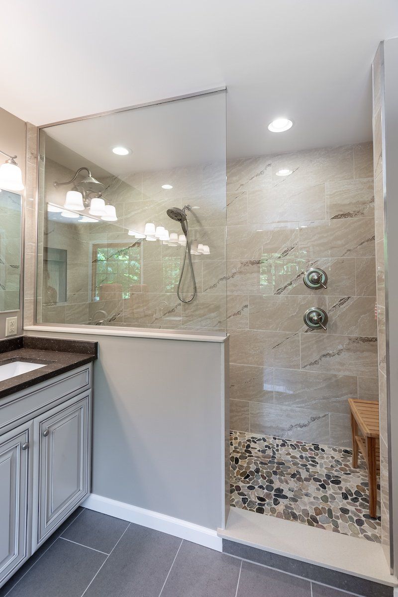 Pietra Vezio Biege 12x24 Tiled Shower Wall, Mixed River Pebble Shower Floor,  and Eternal Emparador Silestone Double Vanity Countertop, Dimensions Gris 12x24 Tile Flooring