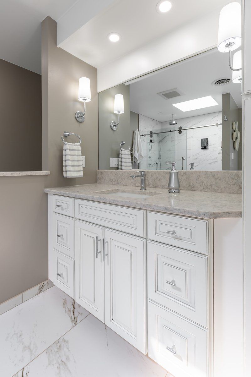 Rolling Fog Q Quartz Countertop with Eased Edge and Painted Pewter Glazed Waypoint Cabinets.  Lazer Carrara floor Tile