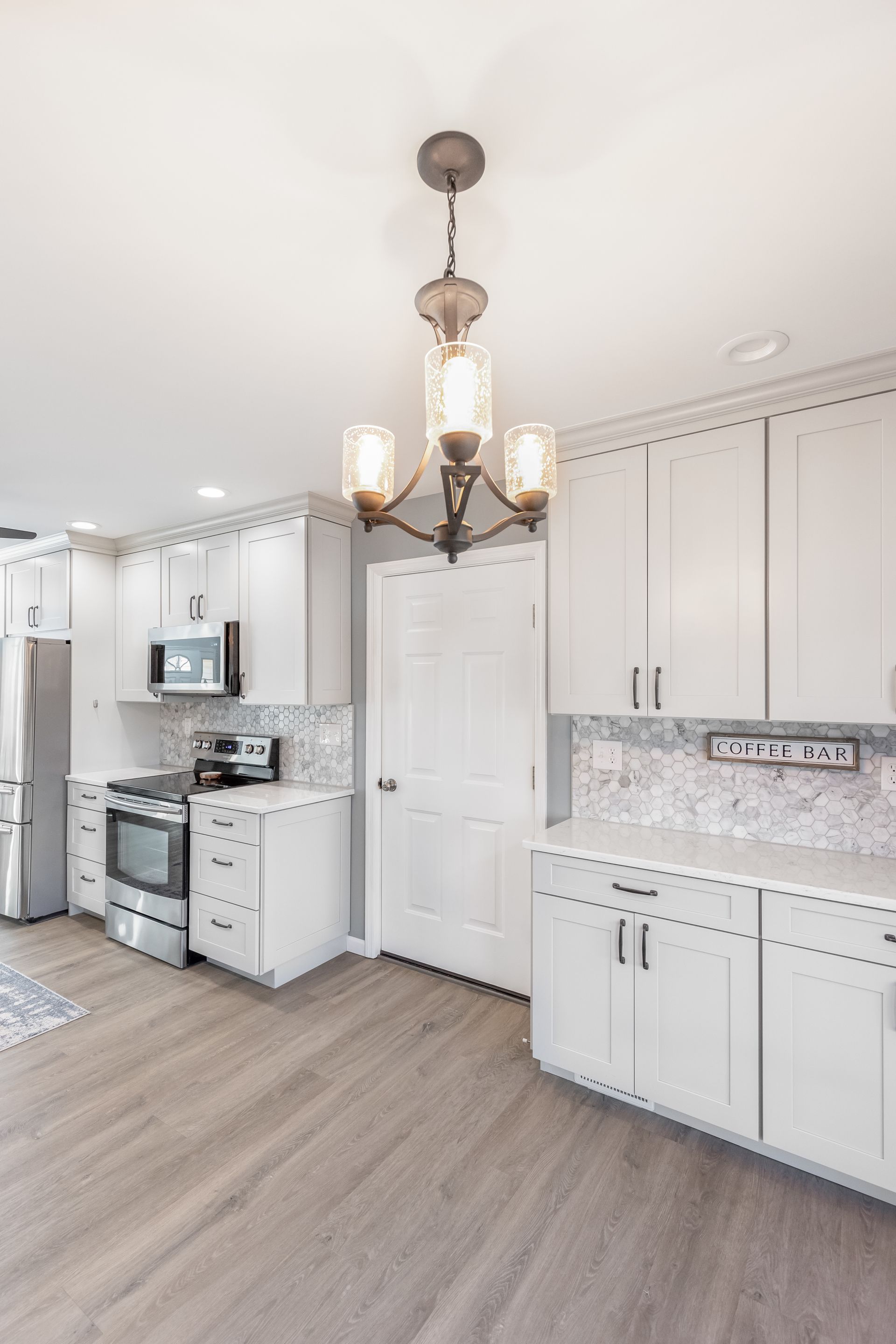 Cashmere Carrara Q Quartz Countertops, and Waypoint Painted Harbor Cabinets
