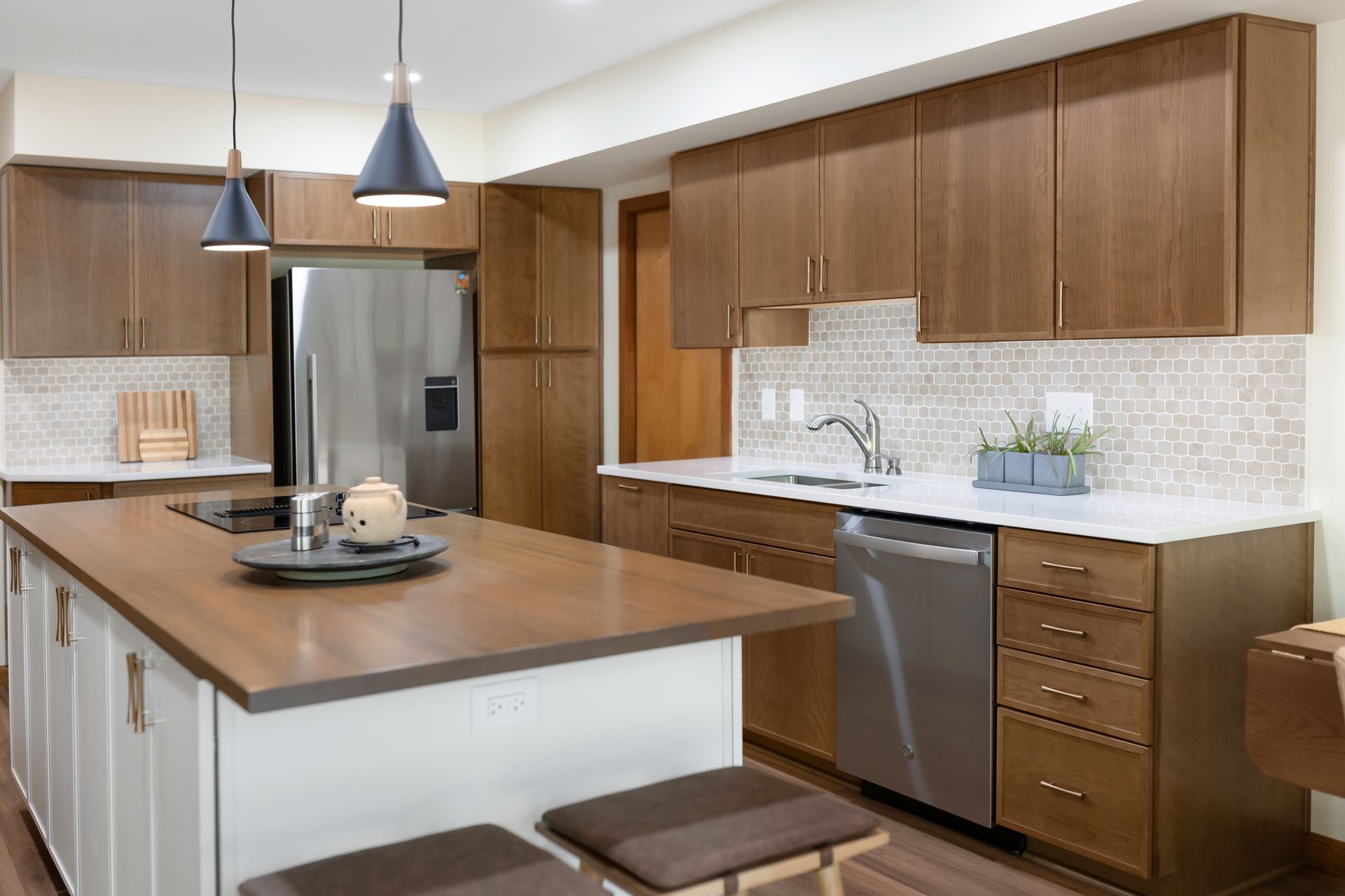 Waypoint Cabinetry in Cherry Amber  and Painted Vanilla Island Cabinets